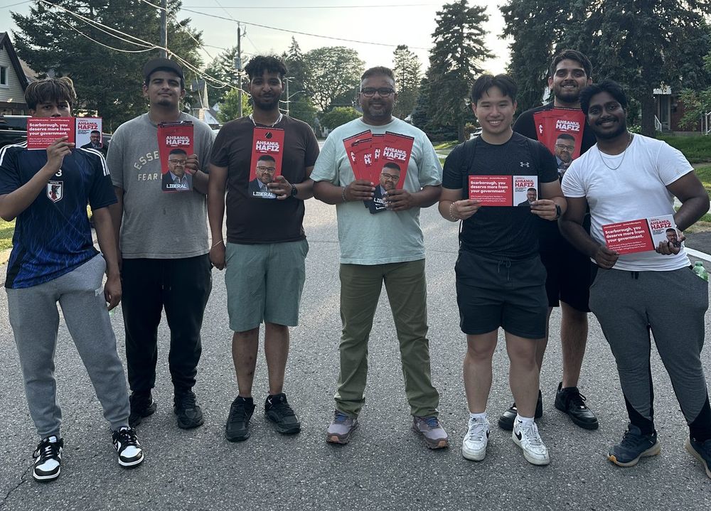 A canvass team of volunteers holding Ahsanul Hafiz signs on a Scarborough street