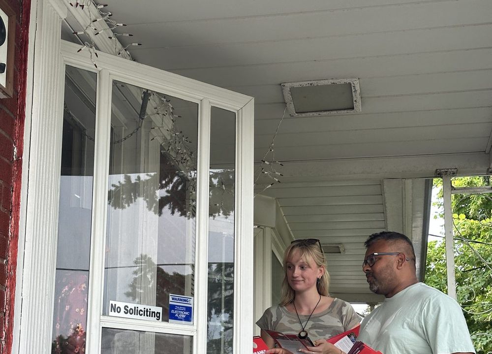 Talking with a resident at her front door while canvassing in Scarborough Southwest
