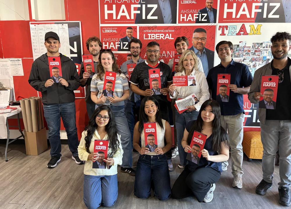 Ahsanul Hafiz with a group of volunteers and campaign signs at the campaign office