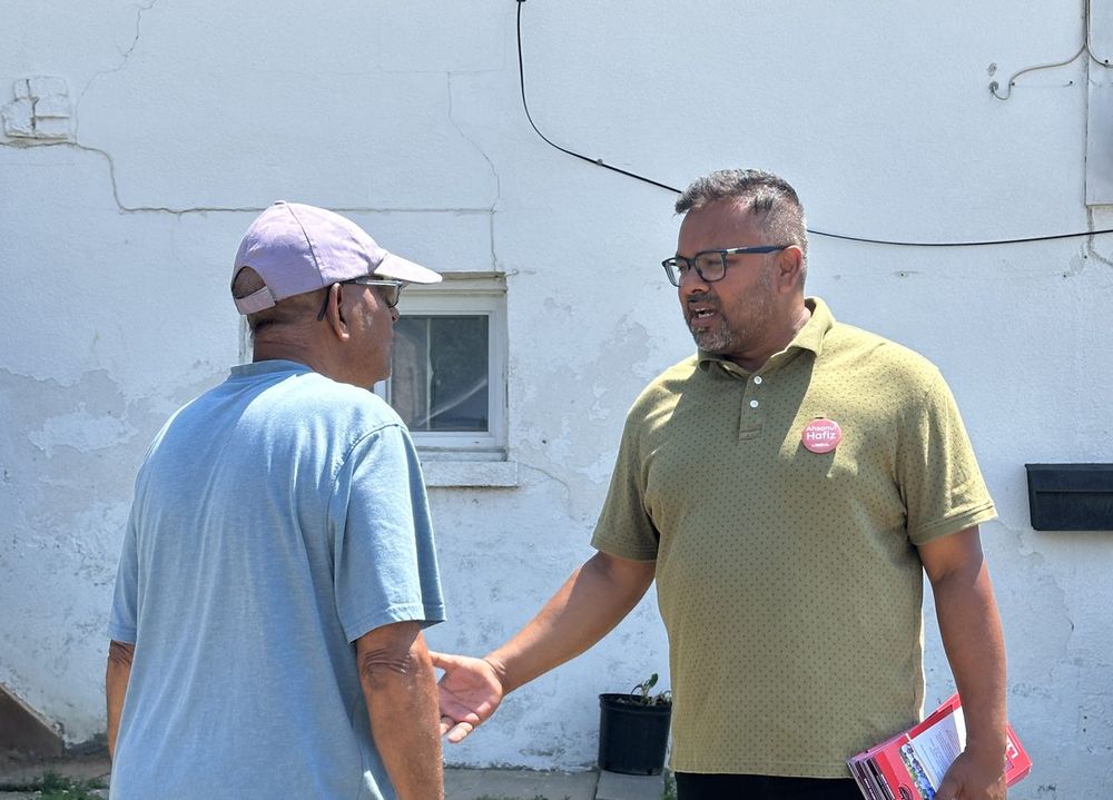 Ahsanul Hafiz shaking hands with a resident while canvassing