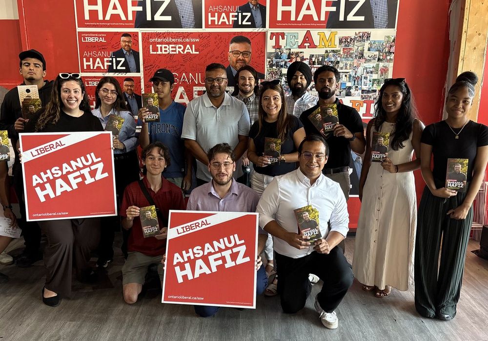 Young volunteers holding Ahsanul Hafiz signs at the campaign office